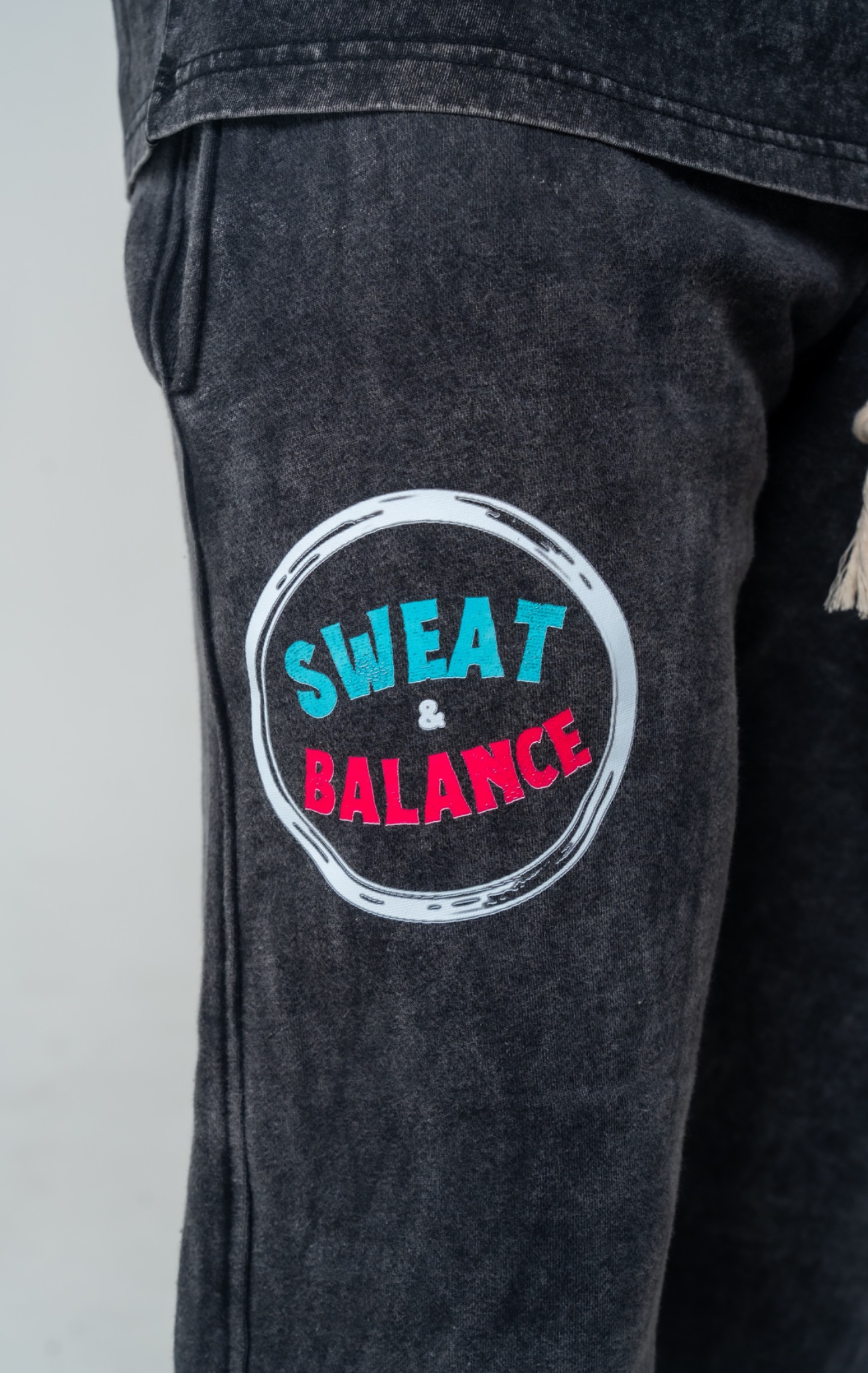 Sweat and Balance logo on charcoal shorts